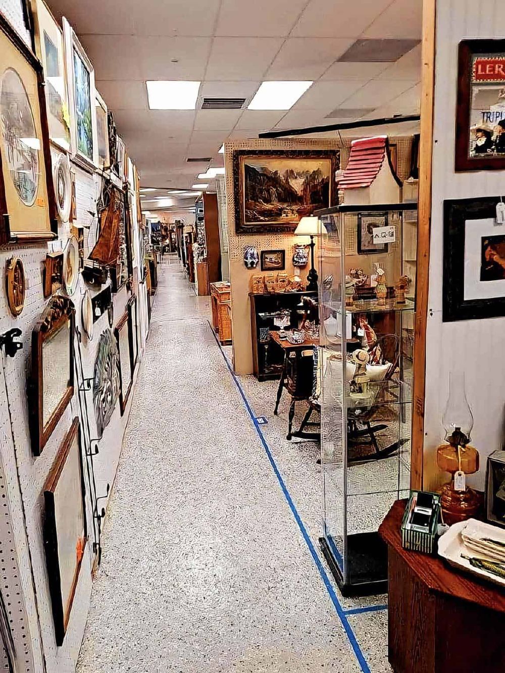 Vintage thrift store with eclectic furniture, art, and collectibles, offering unique finds and antiques.