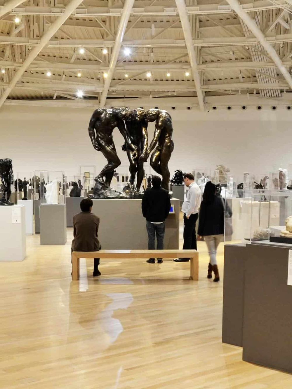 Elegant bronze sculpture of human figures at QuestForDirections museum exhibit.