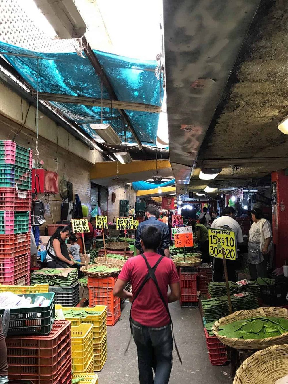 Colorful marketplace with fresh produce and shoppers, vibrant local vendor scene.