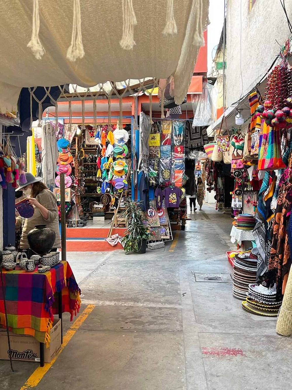 Vibrant Mexican market with colorful textiles, accessories, and handcrafted souvenirs.