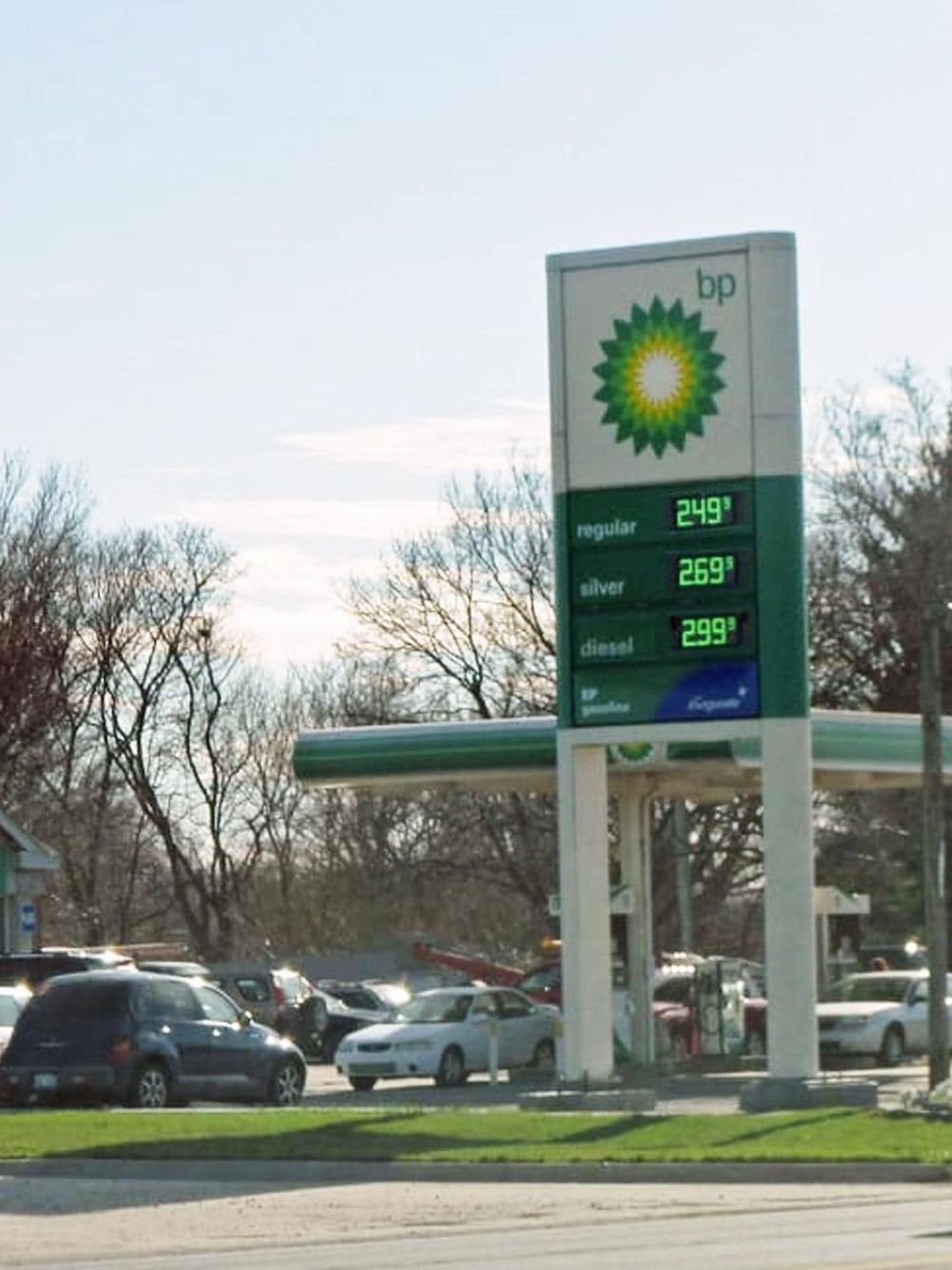 Gas station with BP fuel prices, including regular, silver, and diesel, outdoors on a clear day.