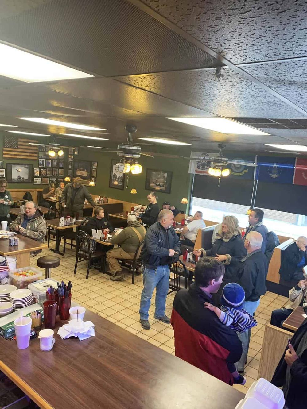 Warm, family-friendly restaurant interior with people dining and socializing, showcasing welcoming atmosphere for QuestForDirections SEO.