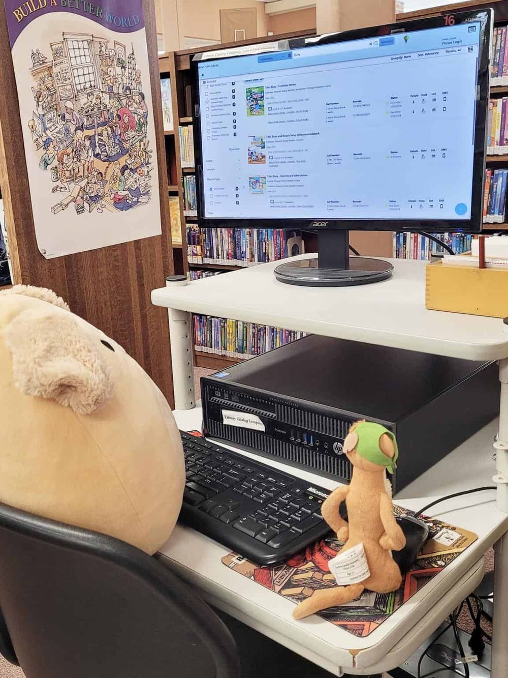 Computer workstation at library with mascot plush, guiding students using QuestForDirections app.