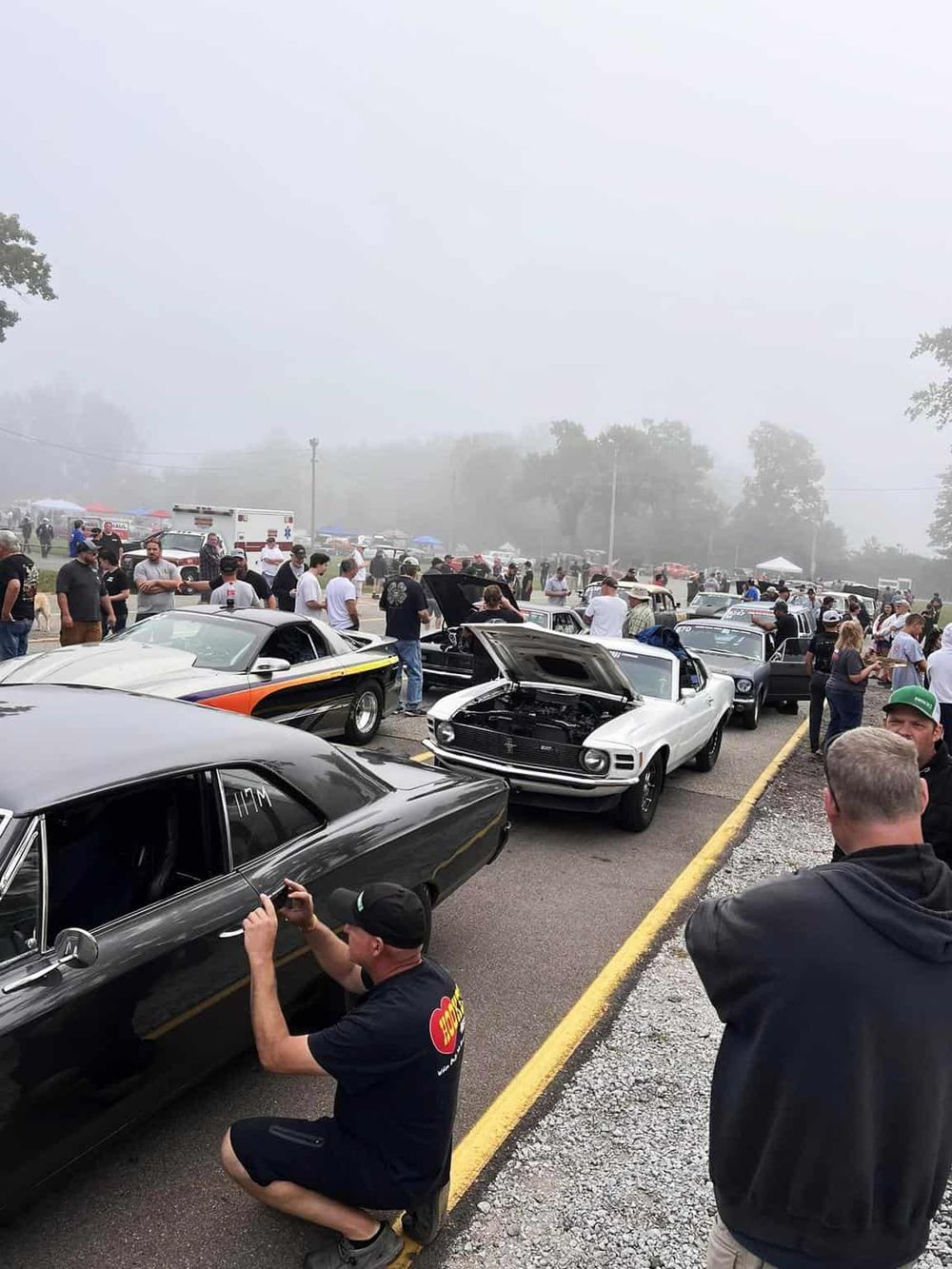 Classic car show at QuestForDirections with vintage muscle cars and car enthusiasts.