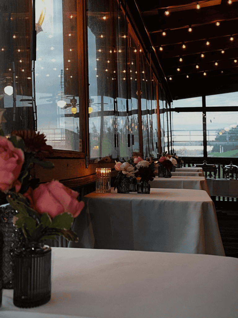 Indoor restaurant dining with elegant decor, flowers, and warm lighting for a cozy dining experience.