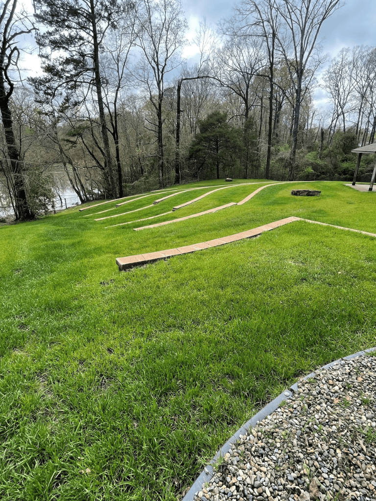 Spiritual garden with terraced landscape and lush greenery in natural park setting.