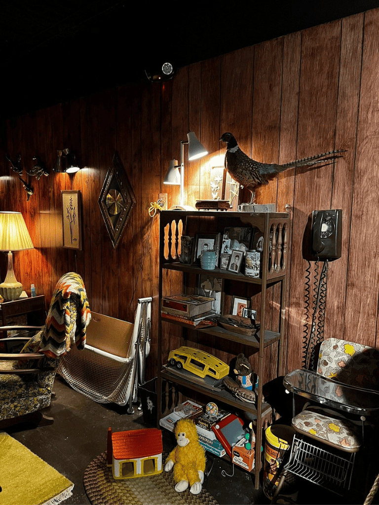 Vintage cozy room with wooden walls, eclectic decor, and collectibles. Perfect for comfort and nostalgic decor.