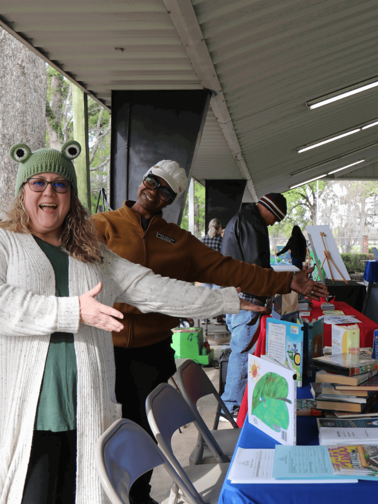 Enjoying community events at QuestForDirections with books and artwork display.