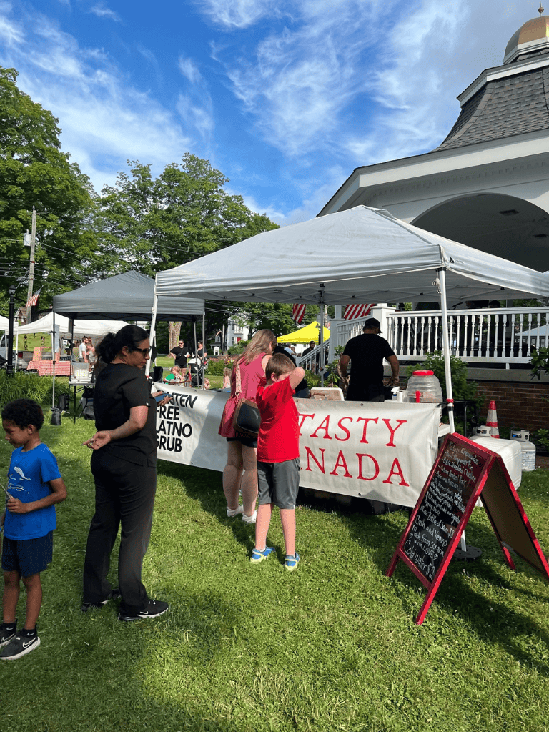 Fresh food vendors at outdoor community event, summer festival, family-friendly market.