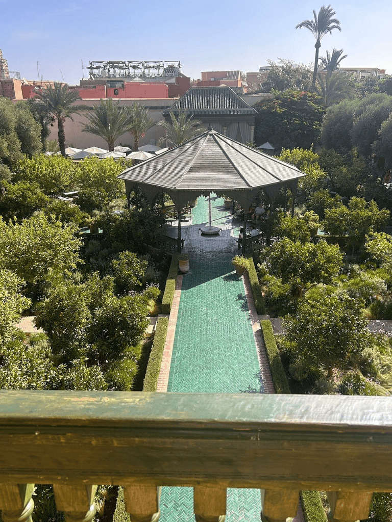 Lush garden with pool and gazebo at QuestForDirections hotel in Morocco.