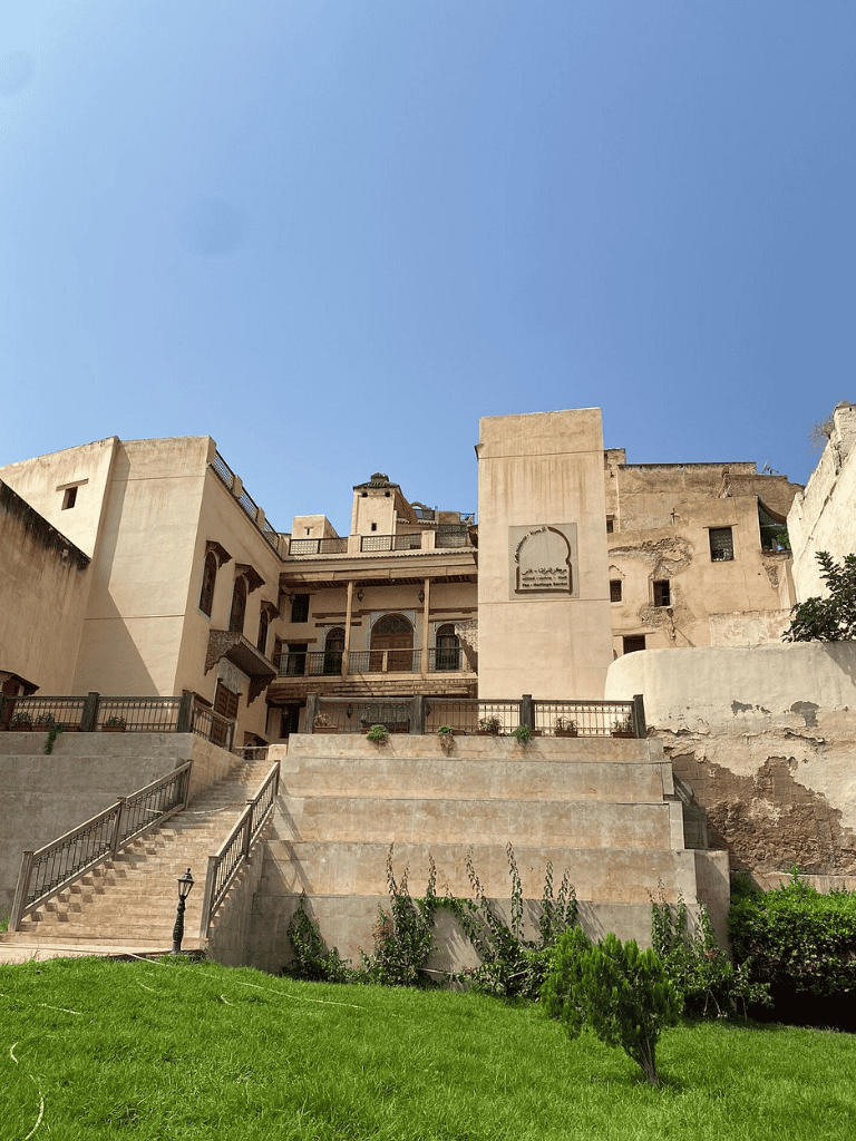 Ancient traditional house with multiple levels and terraces in a historic city setting.