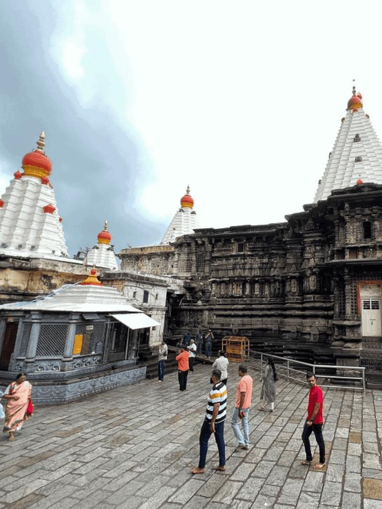 Ancient Hindu temple with pilgrims and visitors, sacred architecture, spiritual travel destination.