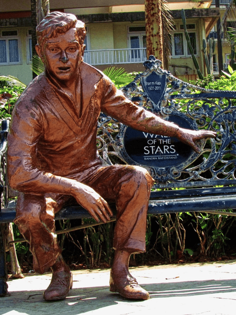 Bronze statue of a seated man at Bandra-Worli Sea Link, Mumbai.