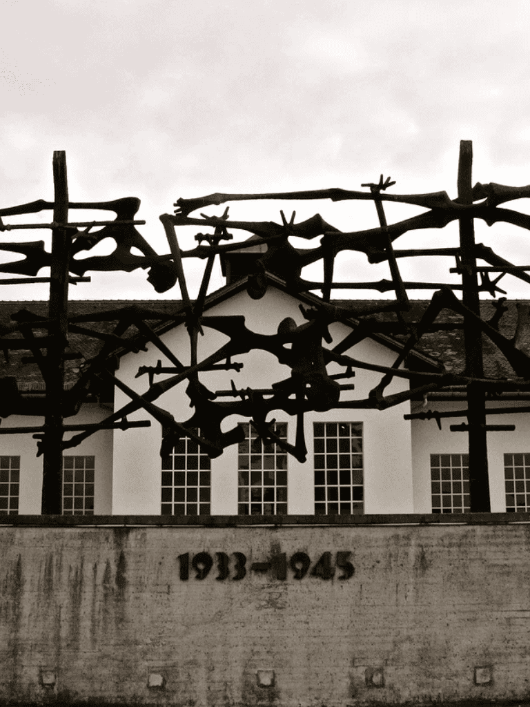 Memorial sculpture at WWII concentration camp with the years 1933-1945 in black text.