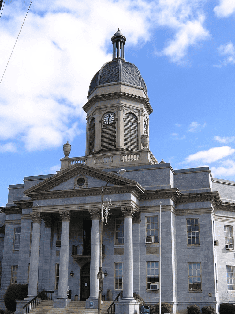 Historic courthouse with clock tower and neoclassical architecture.