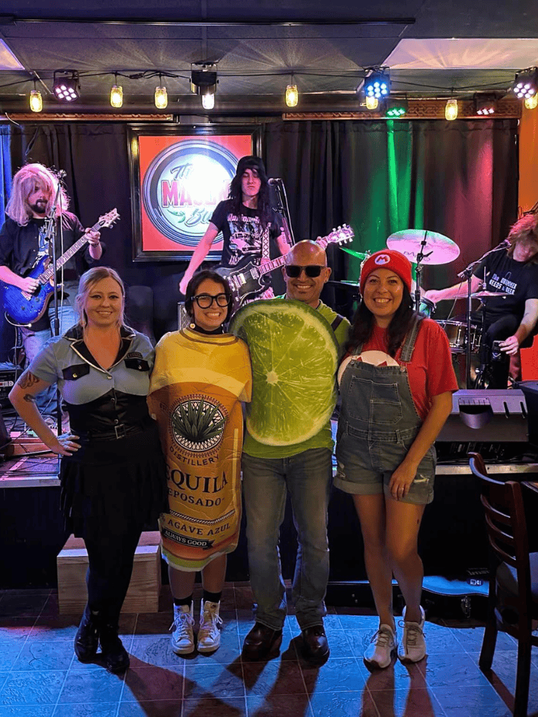 Colorful live music performance with crowd enjoying in a vibrant venue.