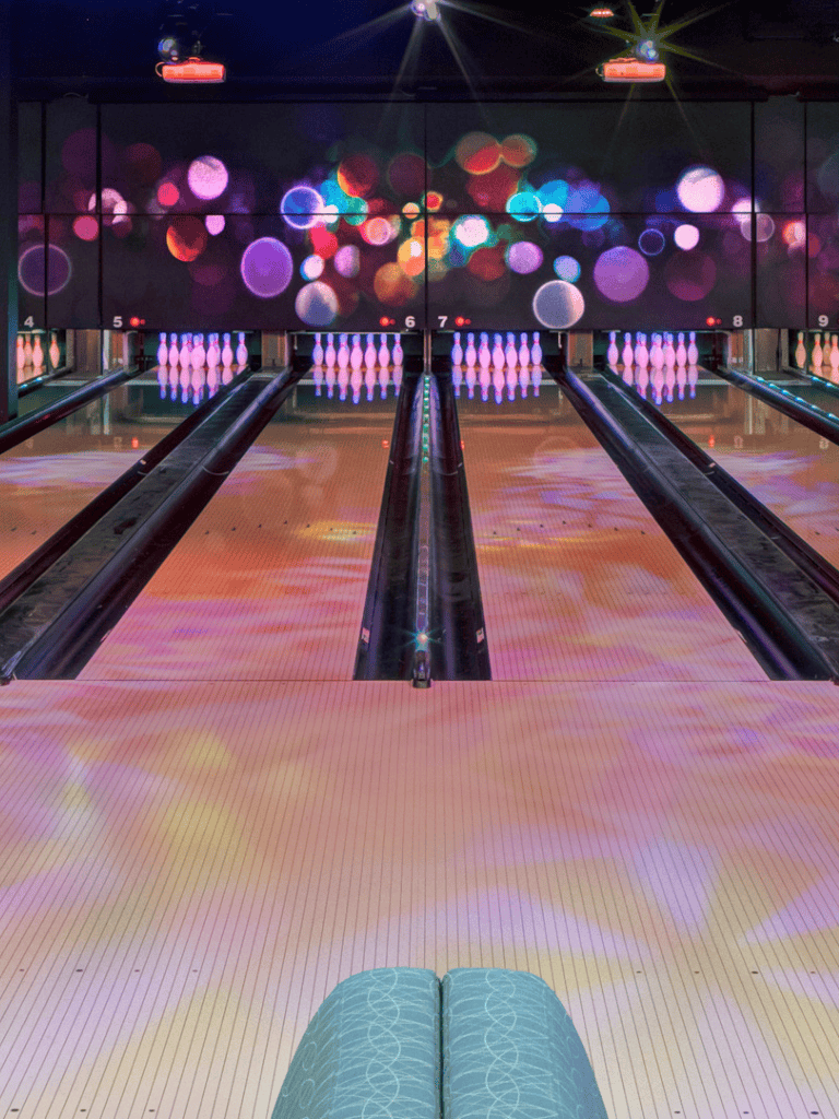 Colorful bowling alley with vibrant lights and state-of-the-art lanes.