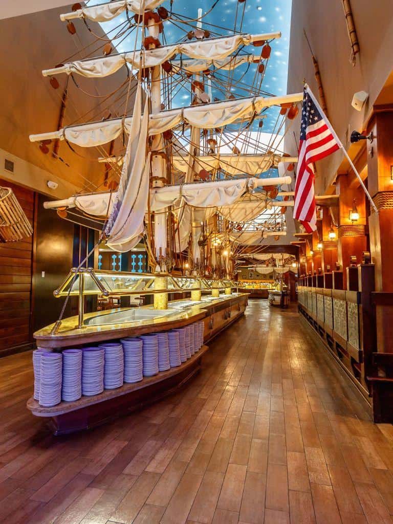 Ship-themed restaurant interior with nautical decor and an American flag.