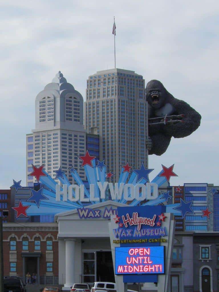 Giant King Kong sculpture on Hollywood billboard outside Wax Museum, entertainment attracting tourists in LA.