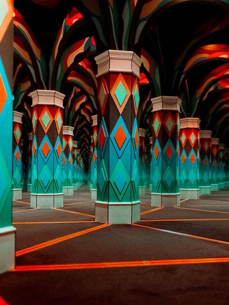 Vibrant colorful illuminated geometric patterned columns at QuestForDirections space.