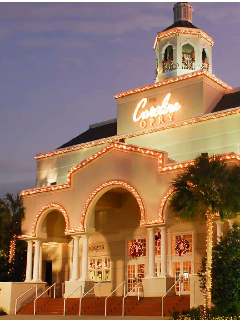 Festive Christmas decor at the Candytopia amusement park during holiday season. Bright lights, wreaths, and holiday cheer create a magical atmosphere.