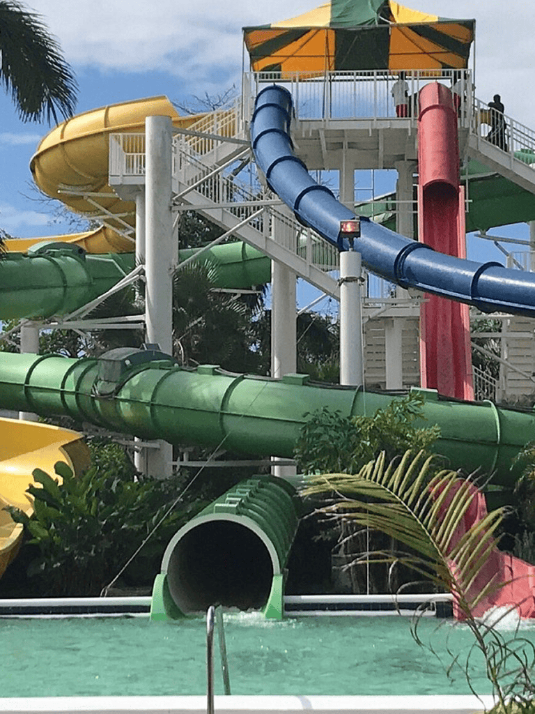 Colorful water slides at Quest for Directions water park, tropical outdoor fun and adventure.