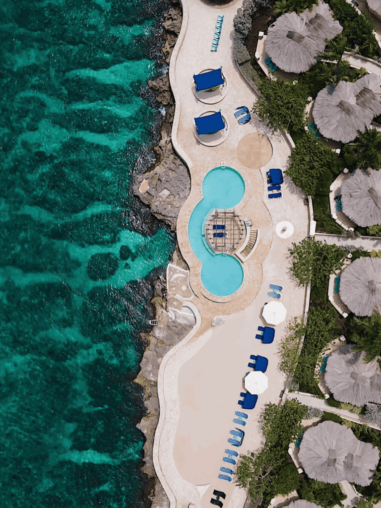 Relaxing Poolside in Paradise with Ocean Views and Sun Loungers.
