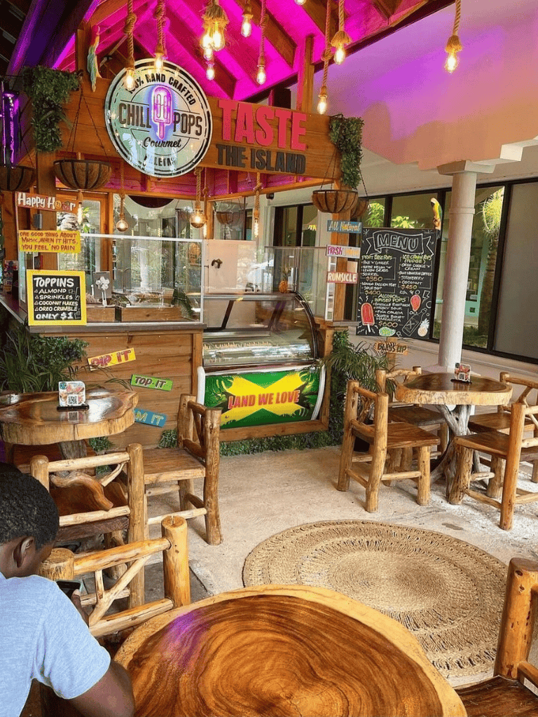 Vibrant tropical-themed restaurant interior with rustic wooden furniture and colorful decor.