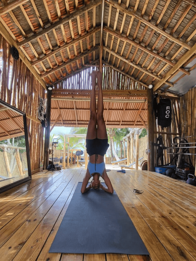 Deep stretch yoga pose in tropical studio for ultimate wellness and relaxation.