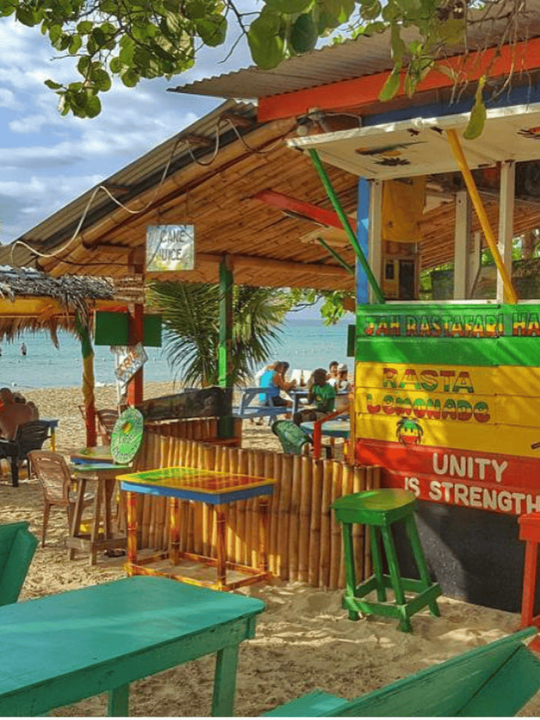 Beachside open-air bar with colorful decor and beach views. Perfect for relaxing and enjoying tropical drinks.