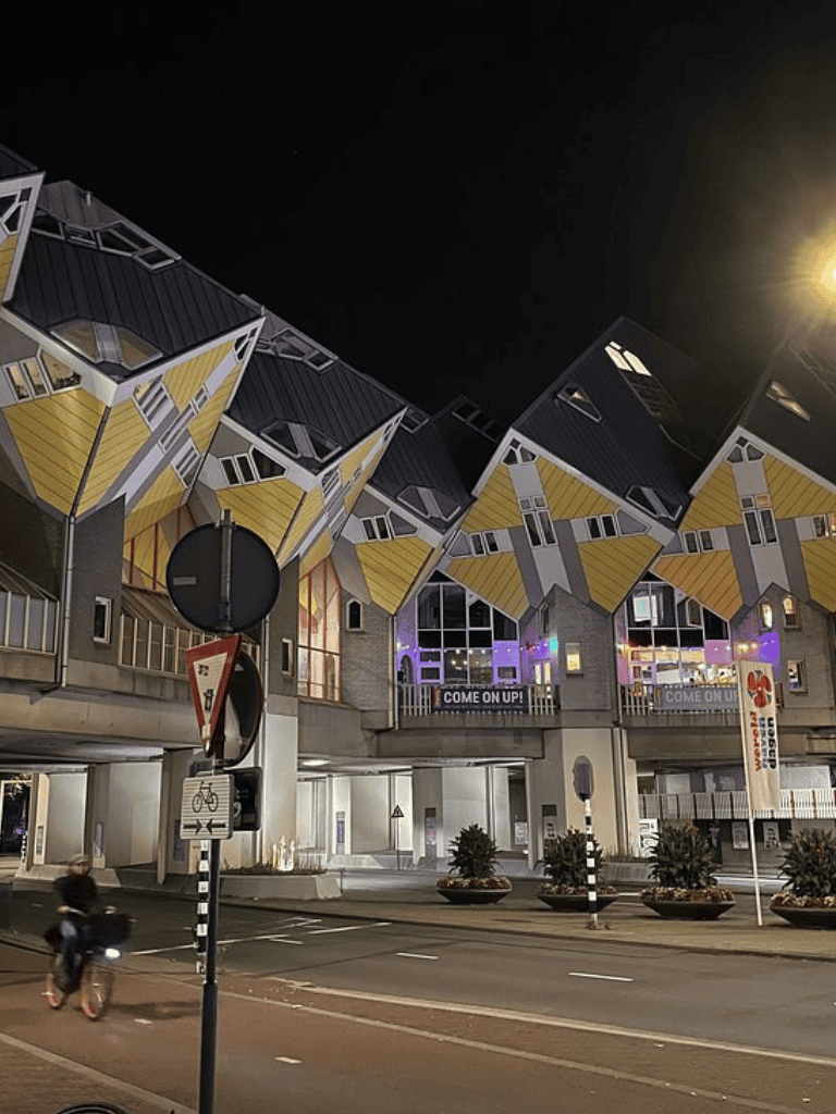Colorful Cube Houses in Rotterdam at night, showcasing unique architecture and real estate innovation.