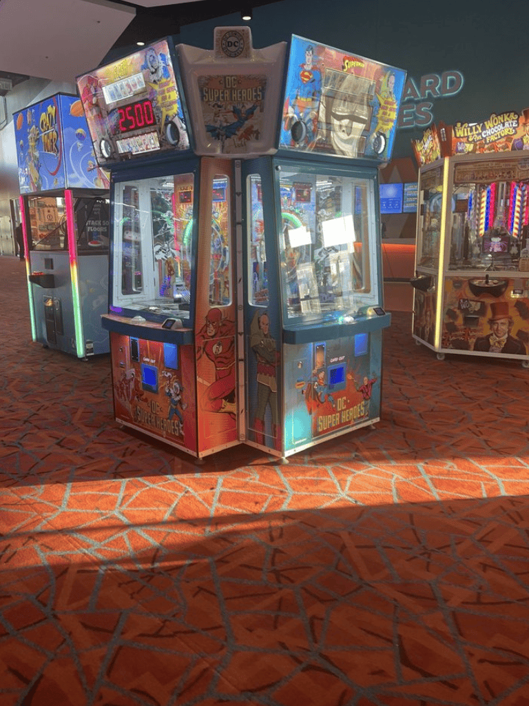 Claw crane arcade game featuring DC Super Heroes in an entertainment center.