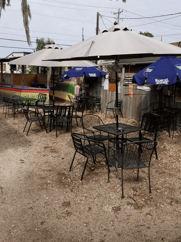 Empty outdoor seating with umbrellas for a restaurant or bar, casual dining area, relaxed atmosphere.