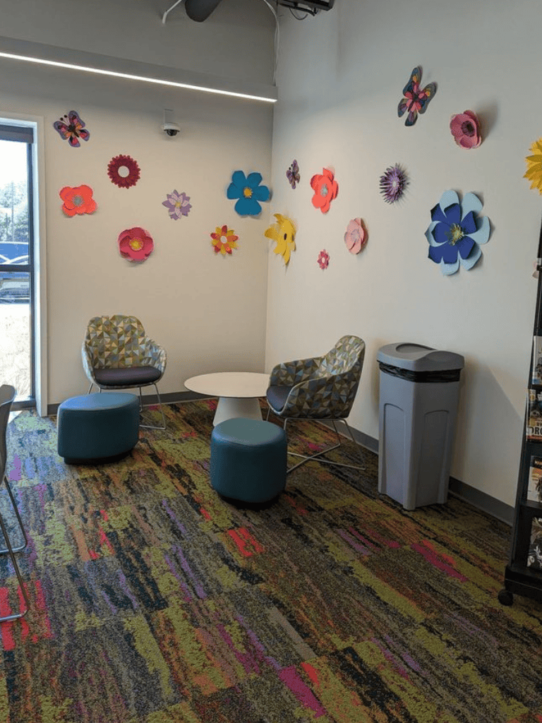 Colorful floral wall decor in a cozy waiting area at QuestForDirections medical office.