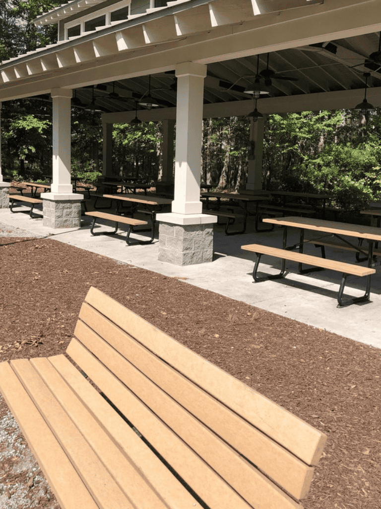 Comfortable outdoor park pavilion with picnic tables, ideal for picnics and gatherings.