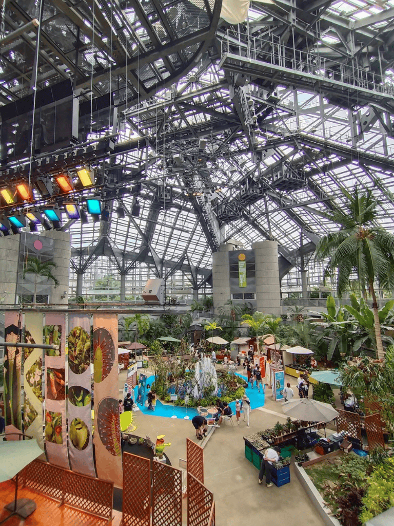 Colorful indoor botanical garden with tropical plants and waterfalls at Quest for Directions.