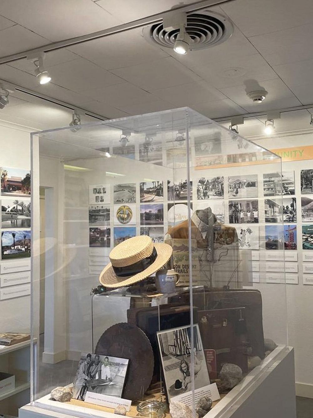 Vintage travel memorabilia display with hats, photos, and artifacts at Quest For Directions.