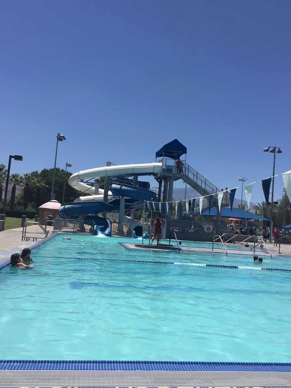 Colorful outdoor water park with water slides and pool, perfect for family fun and summer recreation in QuestForDirections.