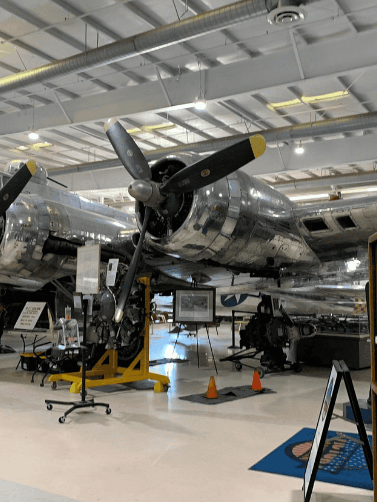 WWII aircraft exhibit at QuestForDirections aviation museum, inside an airplane hangar.