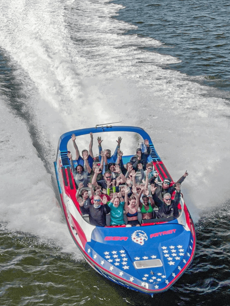 Thrilling speedboat ride with excited passengers on a sunny day for adventure enthusiasts.