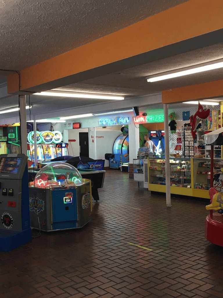 Arcade games and prize area at QuestForDirections indoor entertainment center.