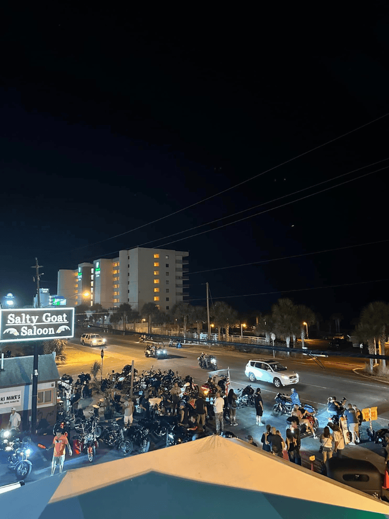 Nightlife scene at Salty Goat Saloon with motorcycles and people, perfect for nightlife and entertainment keywords.