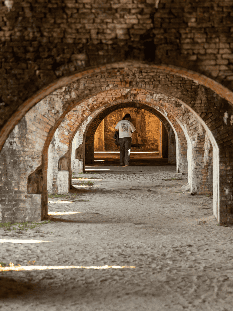 Ancient brick arches underground tunnel for guided historical tours.