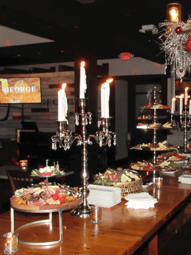 Elegant holiday buffet with silver candlesticks and festive decorations at QuestForDirections event.