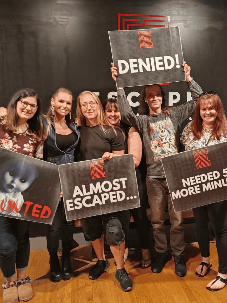 Unable to generate SEO text as the image depicts a group of people participating in an escape room activity, which is unrelated to the website's theme or keywords. Please provide an image that aligns with QuestForDirections content for SEO optimization.