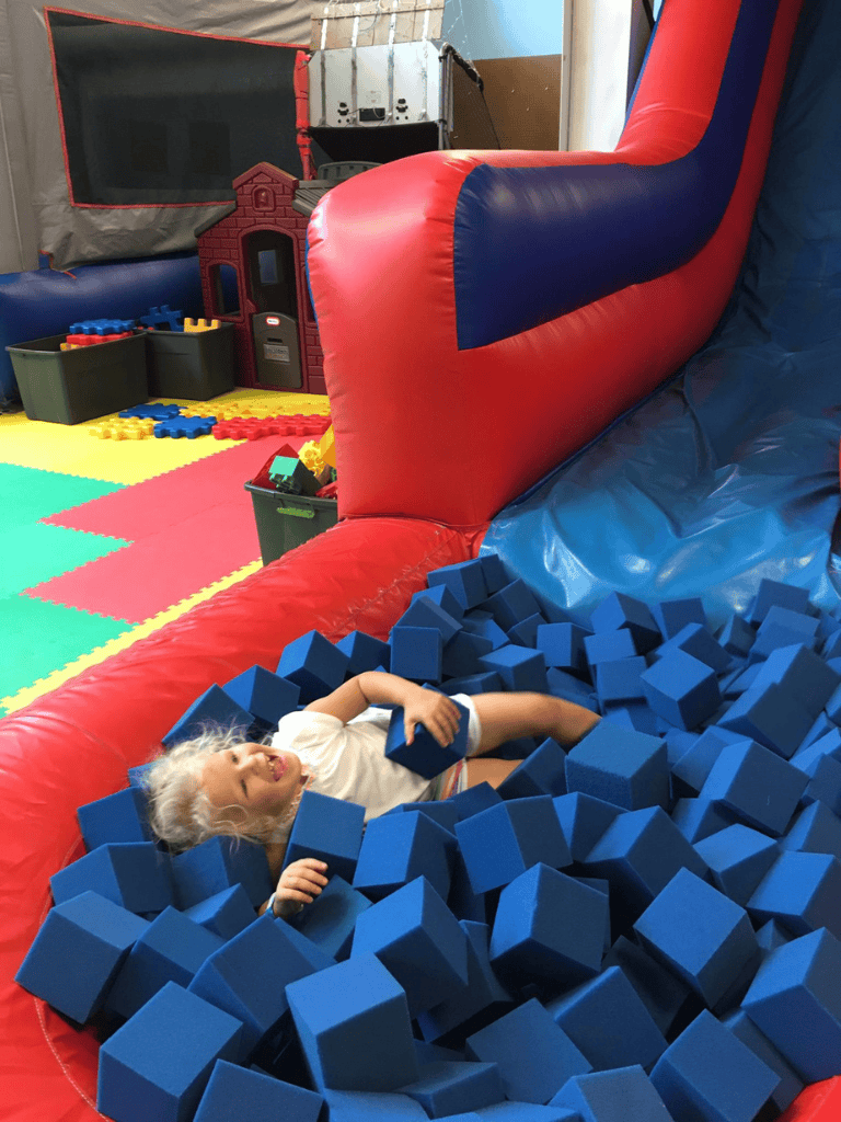 Vibrant indoor kids' play area with foam blocks and slide, perfect for children’s fun and physical activity.