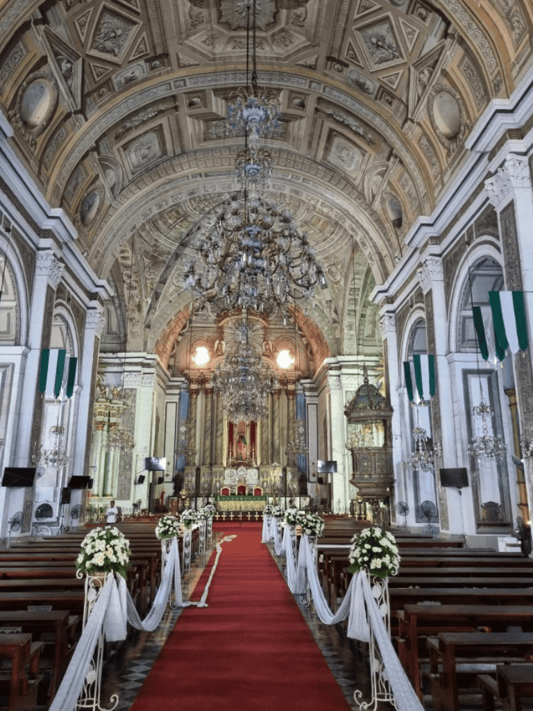 Elegant church interior with ornate decor and grand chandeliers for wedding ceremonies.