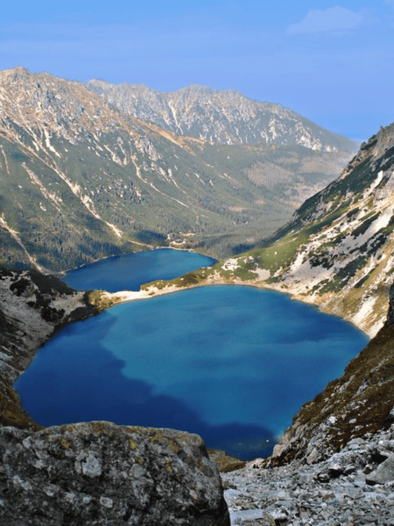 Lakes in a mountain valley with rugged peaks and lush greenery, scenic outdoor destination for hiking and nature exploration.