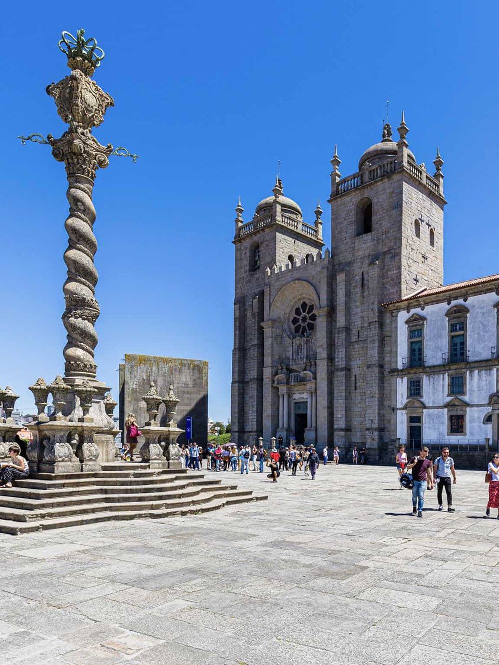 Intriguing historic church with ornate architecture and bustling public square, guiding visitors through Portugal's cultural landmarks.