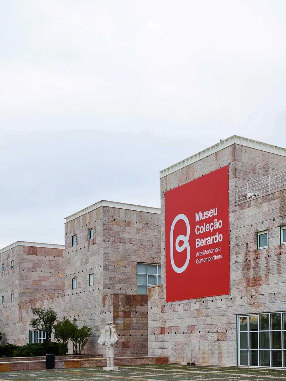 Modern art museum with a large red sign displaying "Museu Coleção Berardo" in Portugal.